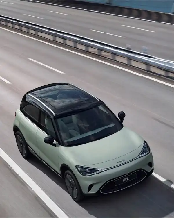 Top view of a green smart #1 electric car driving over a bridge