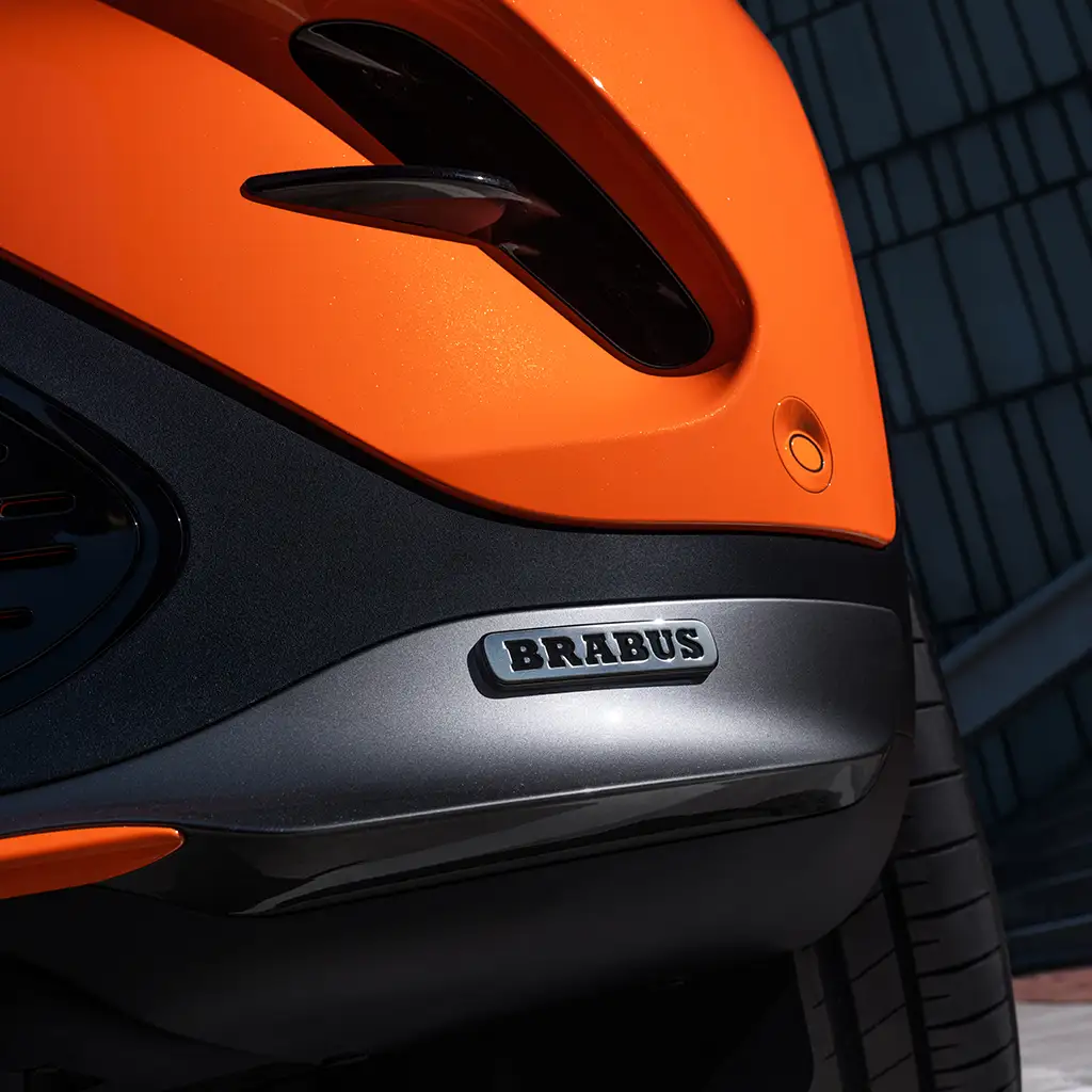 smart BRABUS electric car close-up detail of a rear bumper in orange