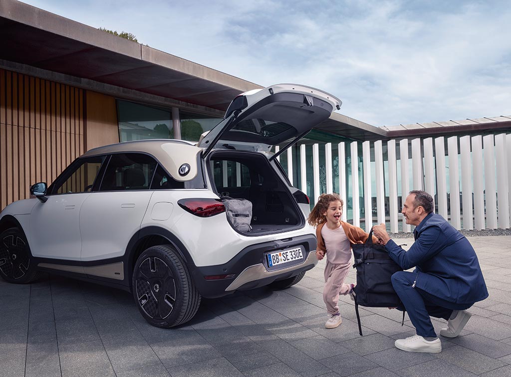 Man and his young daughter next to their white smart #1 electric car