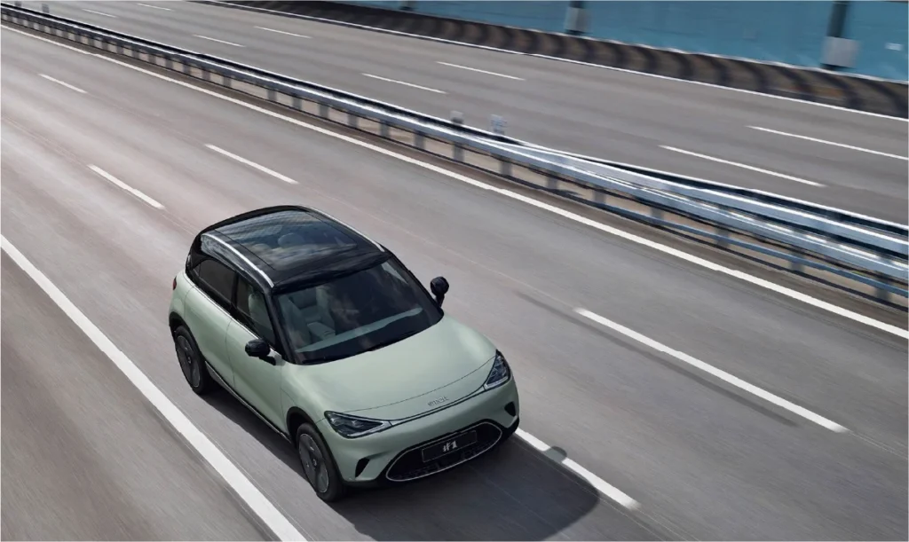 Top view of a green smart #1 electric car driving over a bridge