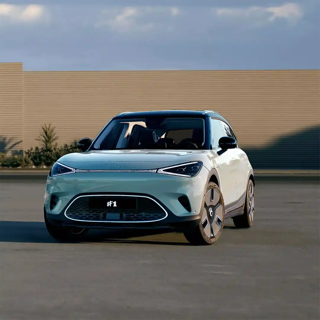 Front three quarter view of a Future Green smart #1 electric SUV parked in front of a wood fence