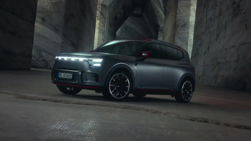 Front three quarter view of a dark grey smart #5 BRABUS electric SUV parked inside a large stone building