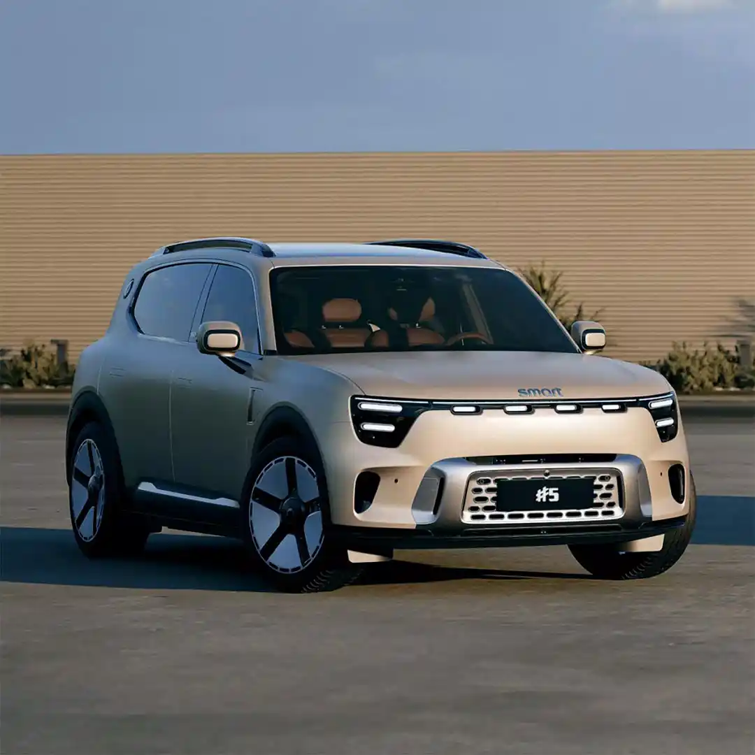 Front three quarter view of a Dune Matte smart #5 electric SUV parked in front of a wood fence