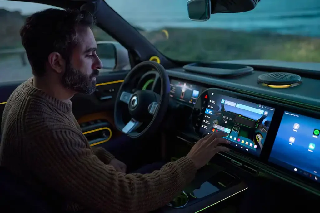Man behind the wheel of a smart #5 electric SUV pressing the large centre touchscreen