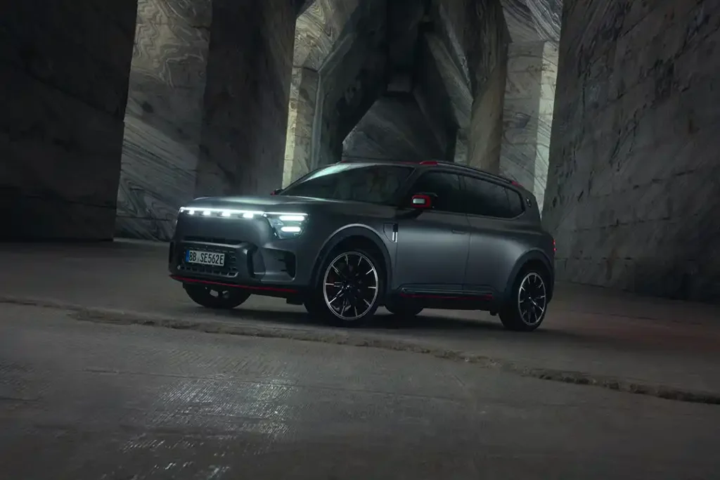Front three quarter view of a dark grey matte smart #5 BRABUS electric SUV parked inside a large stone building